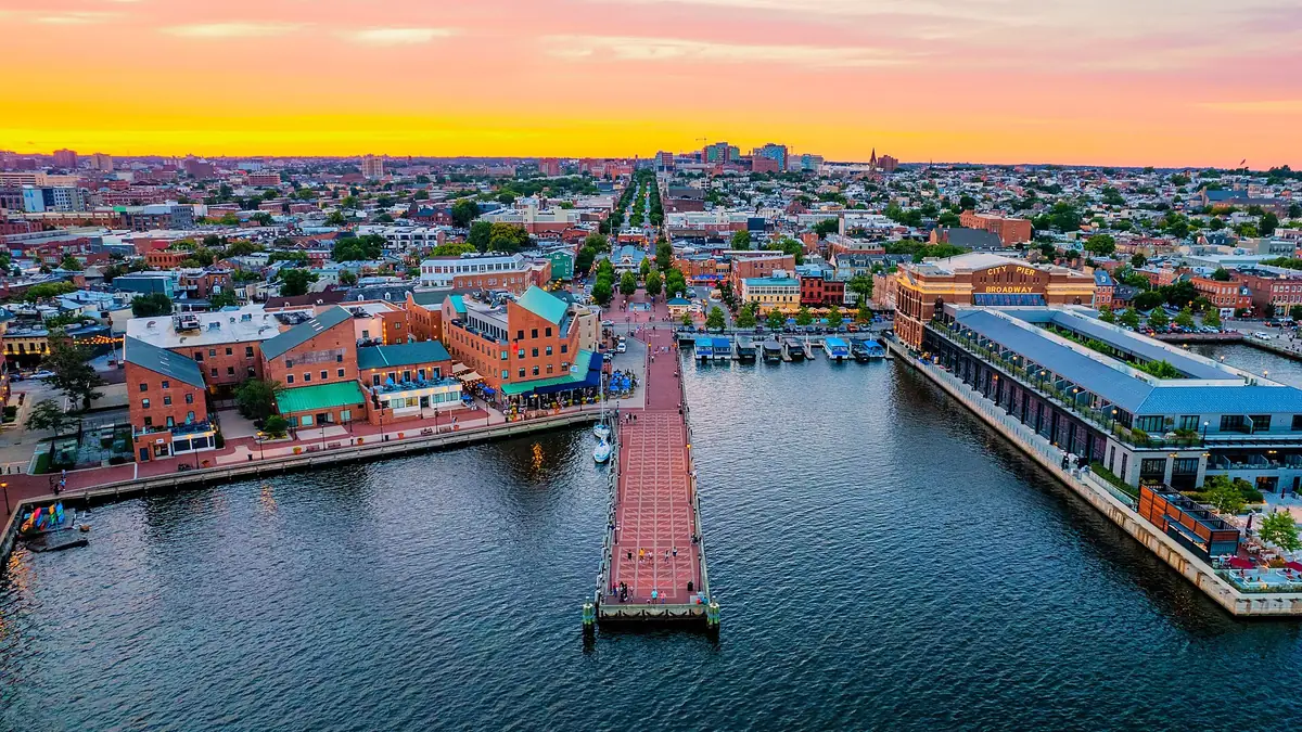 An aerial photograph of the Fell's Point waterfront in Baltimore, in June 2022 at sunset